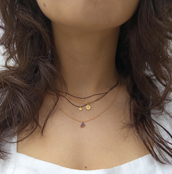 Gold necklace with tanzanite and garnet gem stones