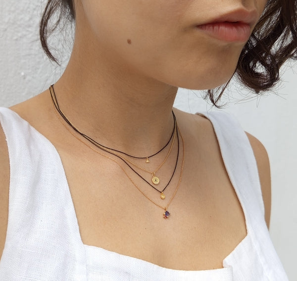 Gold necklace with tanzanite and garnet gem stones