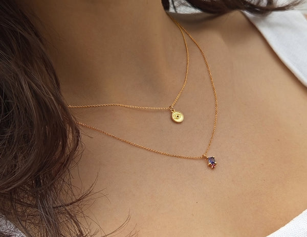 Gold necklace with tanzanite and garnet gem stones