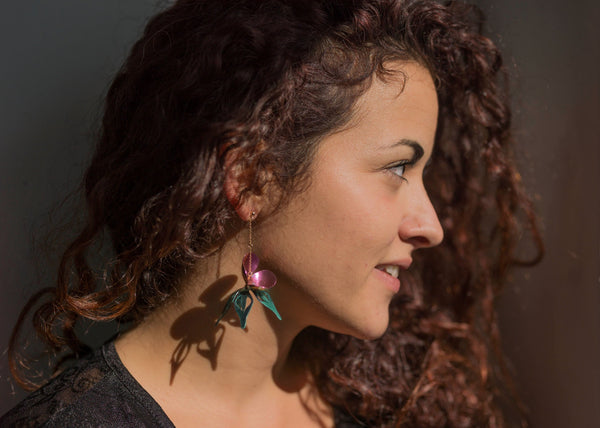 Model wears our handcrafted chain earrings with blue & purple azalea flowers made of titanium, hanging from a lightweight chain, 14ct gold.
