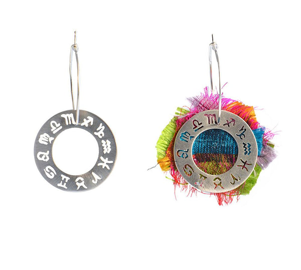 The zodiac circle with the saturated colours of silk as a background in a sterling silver hoop earring