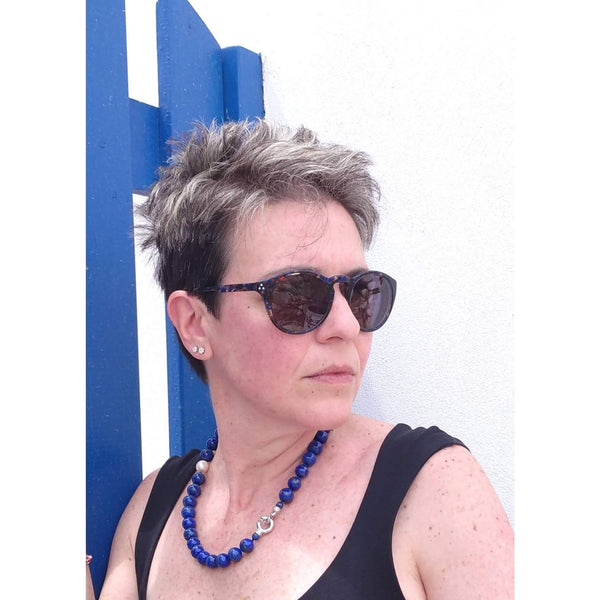 A necklace made of big lapis-lazuli round gems with two fresh-water pearls. A classic piece, yet stylish and creative. Here photographed on our model in the streets of Paroikia
