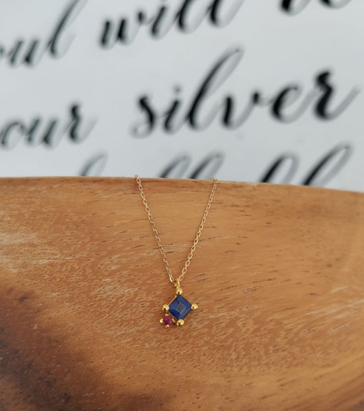 Gold pendant with iolite and ruby