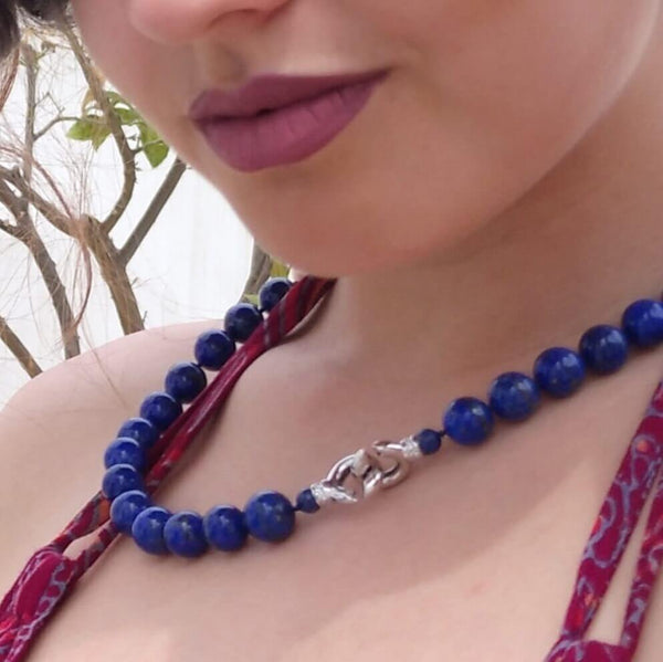 A necklace made of big lapis-lazuli round gems with two fresh-water pearls. A classic piece, yet stylish and creative. Here photographed on our model in the streets of Paroikia