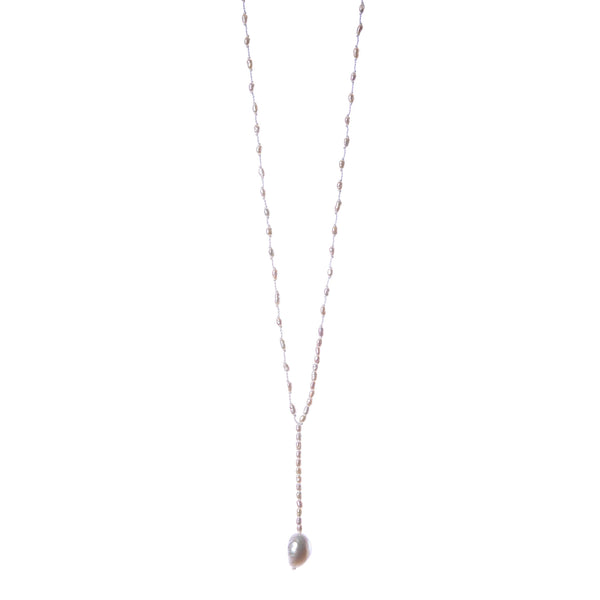 A minimal necklace made of fresh-water fragrant pearls, with silver clasp. the necklace  has the shape of a tie with a bigger pearl at the lower end