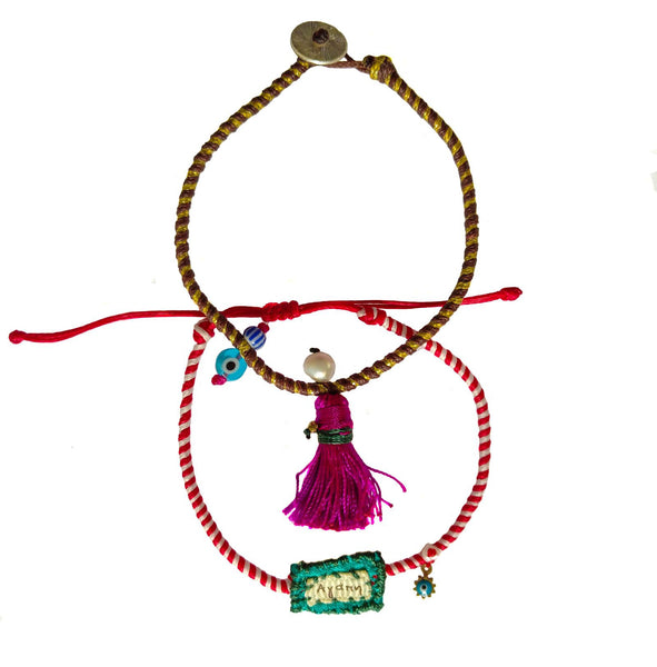 Set of charm bracelets made of silk strings with colorful ornaments in  Fuchsia & Turquoise shades.