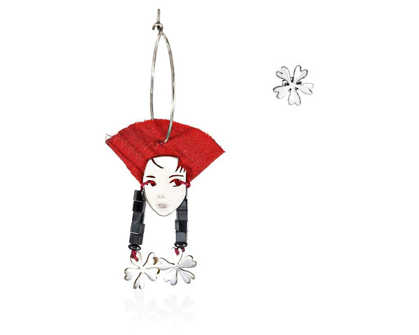 A portrait of a beautifl lady of the far east with her red silk hat and her long hematite  and flower earrings.  Hoop and stud earrings made of sterling silver  gems and silk